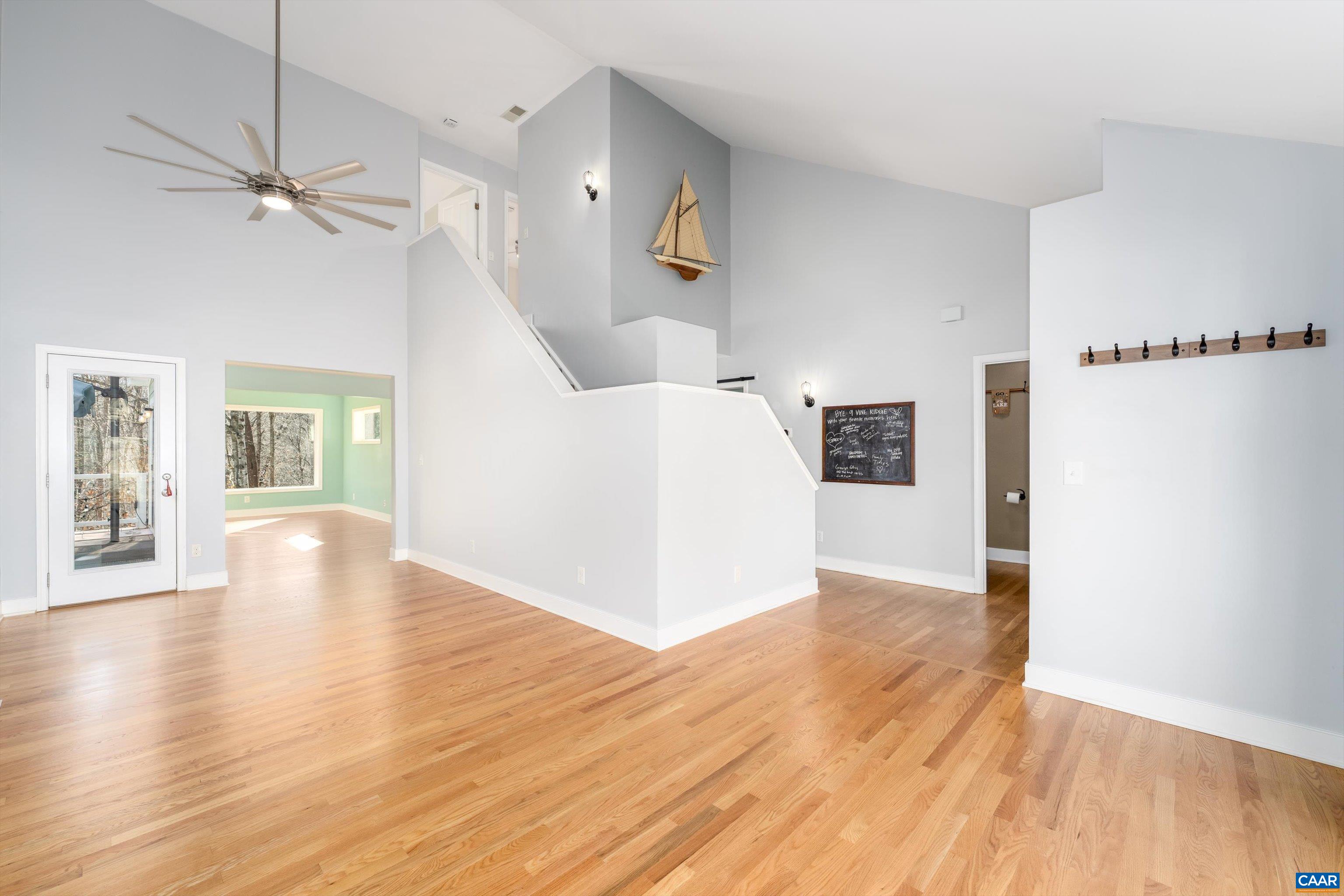 9 Vine Ridge Drive Palmyra, VA 22963 - Photo 15 of 73 a view of a livingroom with wooden floor a ceiling fan and windows