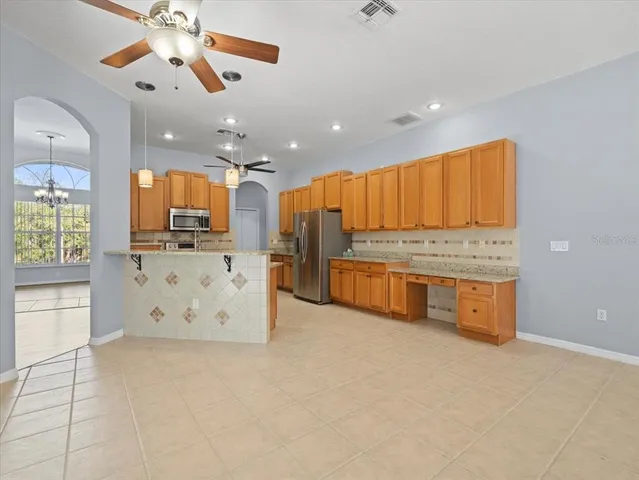 a kitchen with stainless steel appliances a refrigerator stove microwave and sink