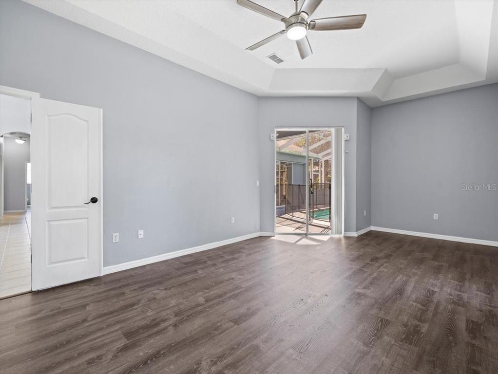 10307 Ridge Top Loop Weeki Wachee, FL 34613 - Photo 26 of 50 a view of an empty room with wooden floor and a window