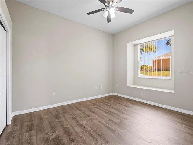 an empty room with windows and closet