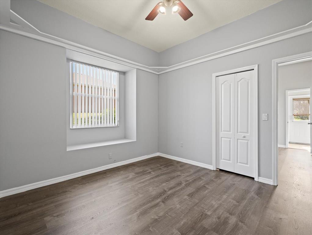 10307 Ridge Top Loop Weeki Wachee, FL 34613 - Photo 37 of 50 an empty room with windows and closet