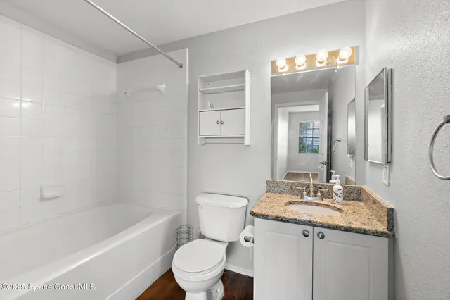 a view of a lake with houses in the back