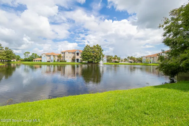 an aerial view of residential houses with outdoor space and ocean view