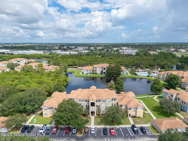 a aerial view of a house with a big yard and large trees