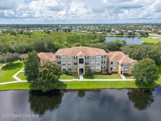 a view of a house with swimming pool and a yard