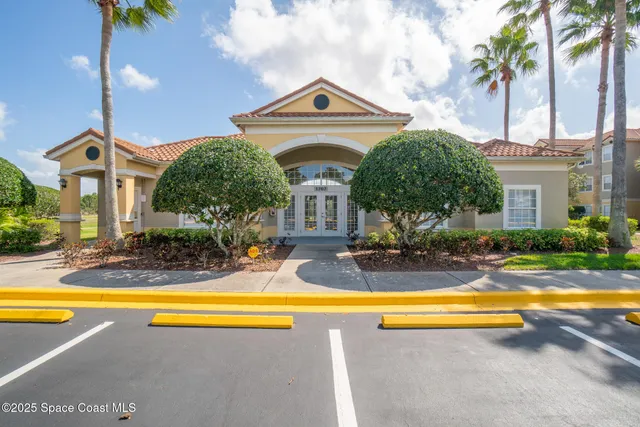 a living room with furniture a flat screen tv and a large window