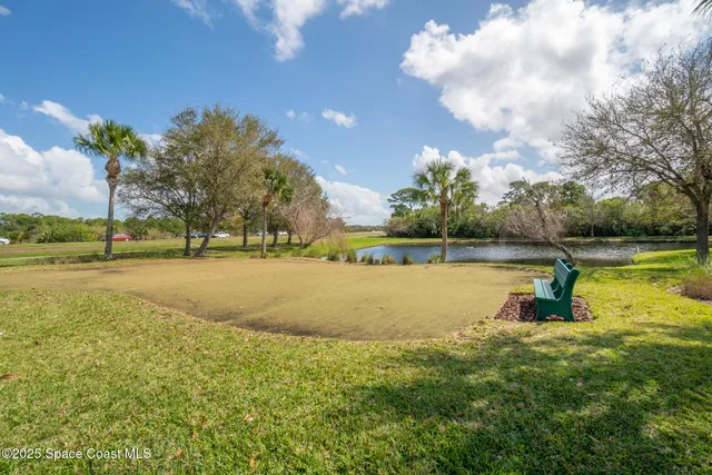 a swimming pool with outdoor seating and barbeque oven