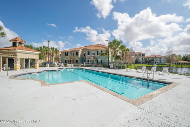 a view of a white house with a yard in front of it