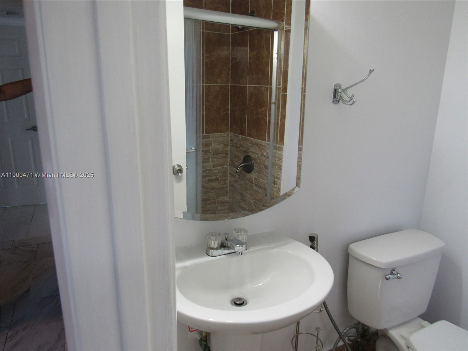 5490 West 21st Court, Unit 308 Hialeah, FL 33016 - Photo 12 of 21 a bathroom with a sink and a toilet