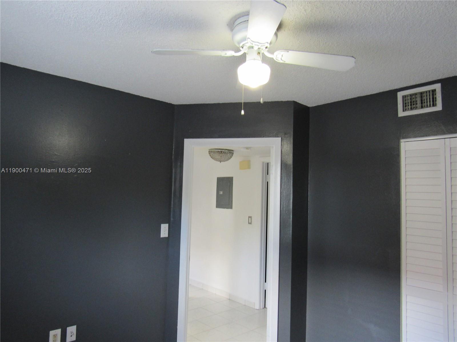 5490 West 21st Court, Unit 308 Hialeah, FL 33016 - Photo 16 of 21 a view of a hallway with a chandelier fan