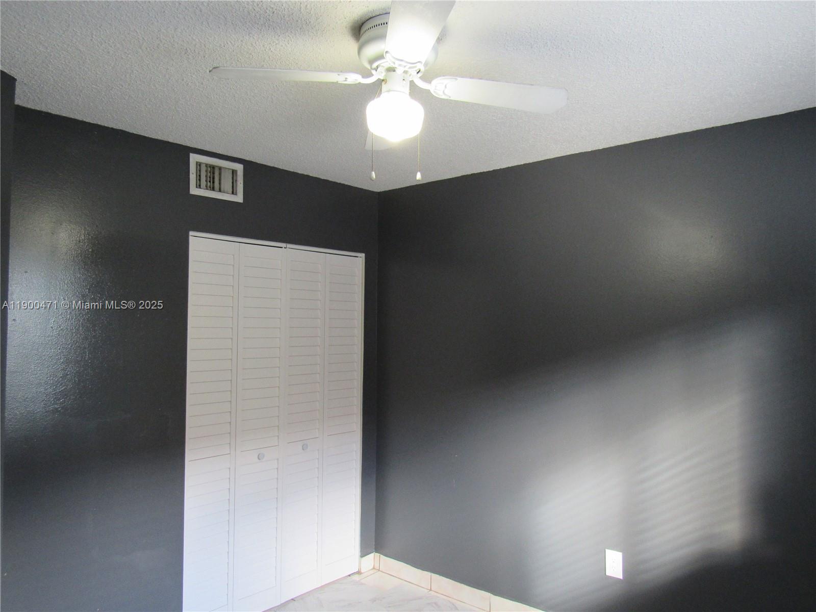 5490 West 21st Court, Unit 308 Hialeah, FL 33016 - Photo 17 of 21 a very nice looking room with a ceiling fan
