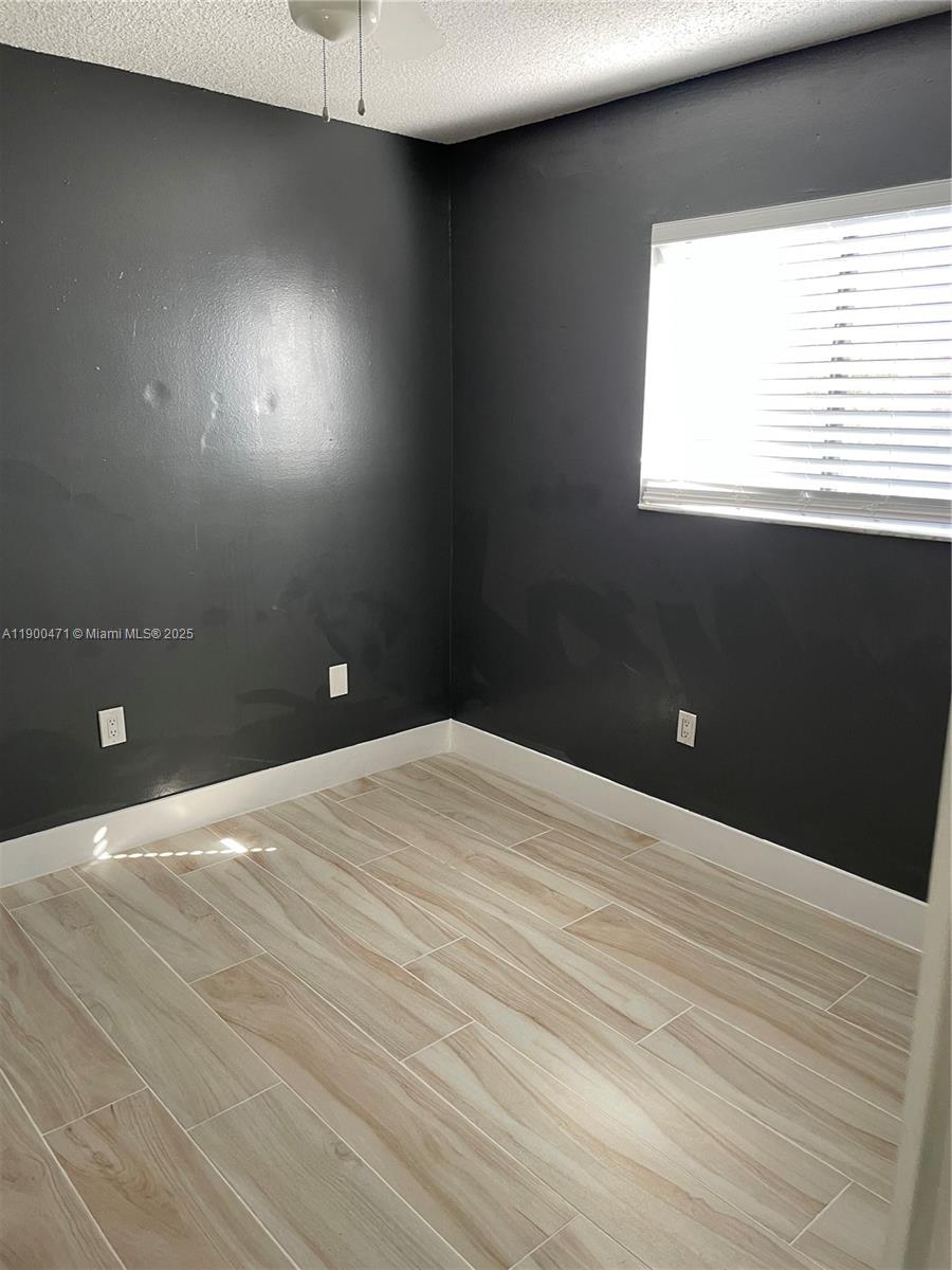 5490 West 21st Court, Unit 308 Hialeah, FL 33016 - Photo 18 of 21 a bedroom with a bed and a window
