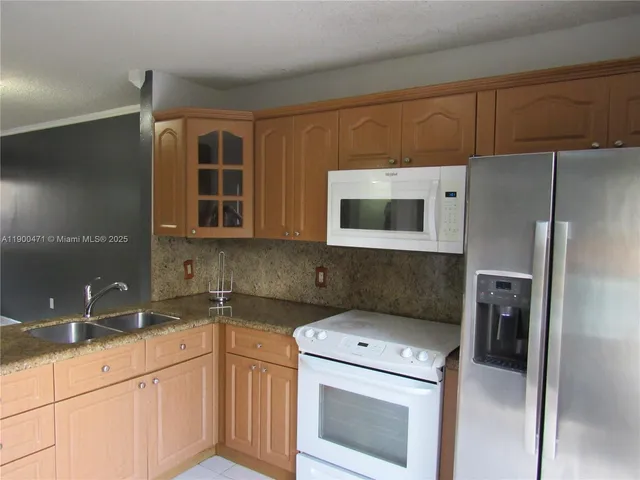a kitchen with a sink and a refrigerator