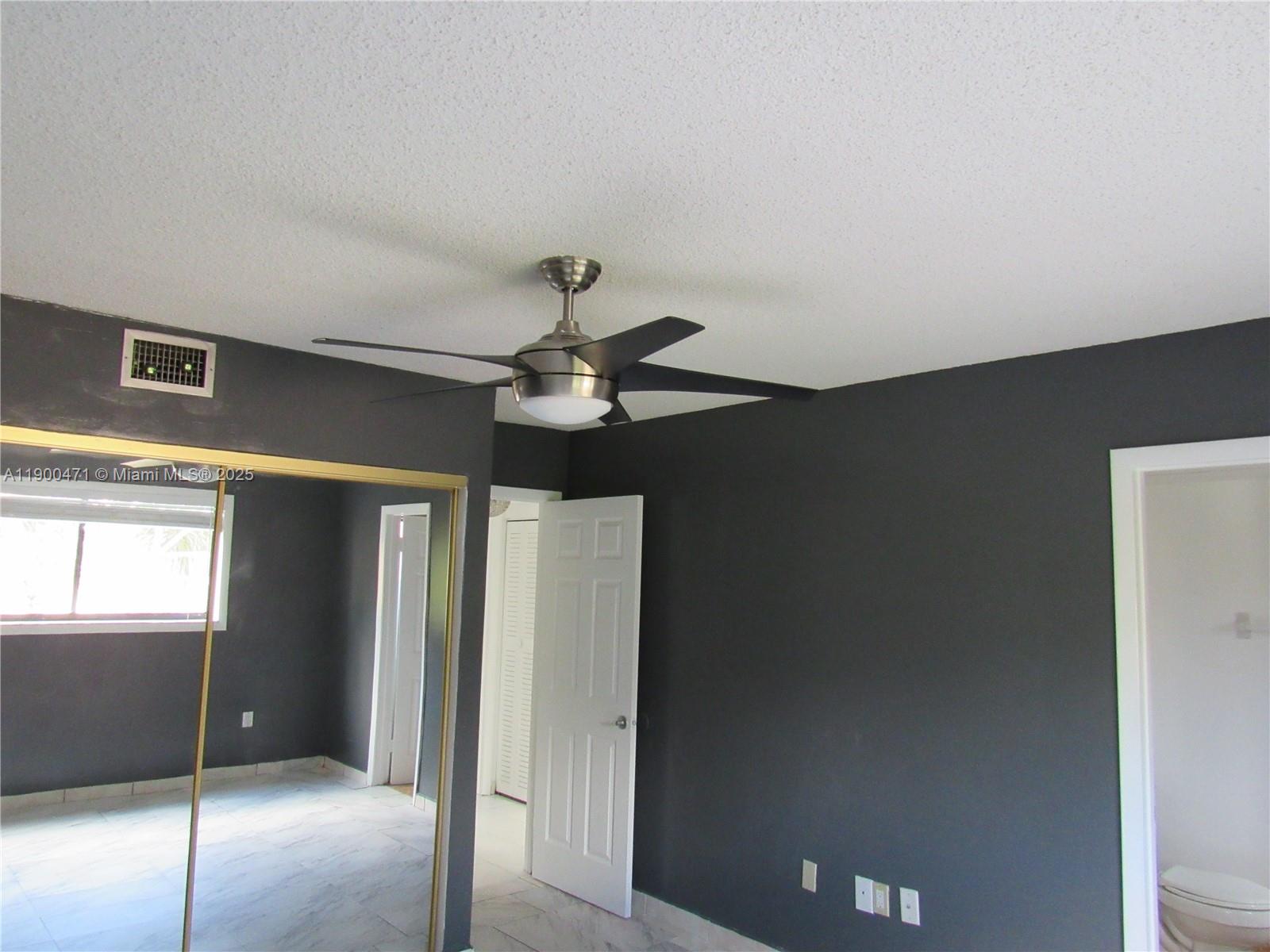 5490 West 21st Court, Unit 308 Hialeah, FL 33016 - Photo 9 of 21 a view of a hallway with a chandelier fan
