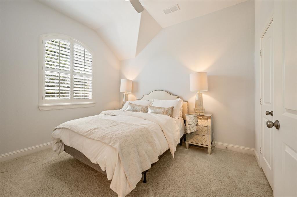 1521 Newton Ranch Road Keller, TX 76248 - Photo 31 of 40 Arched window with plantation shutters, vaulted ceiling, and plush carpet flooring