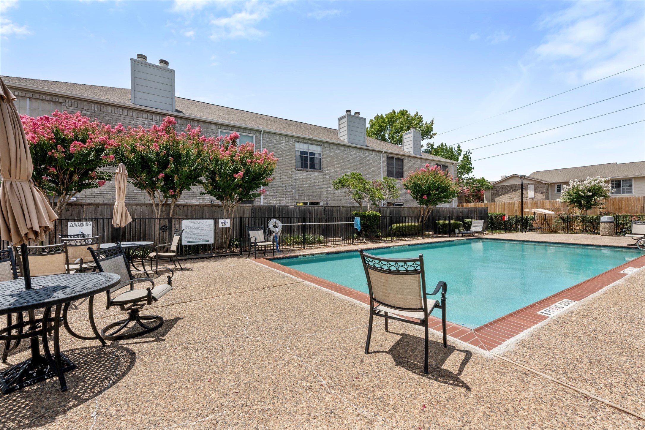7617 Cambridge Street, Unit 7617 Houston, TX 77054 - Photo 1 of 20 a swimming pool with outdoor seating and yard