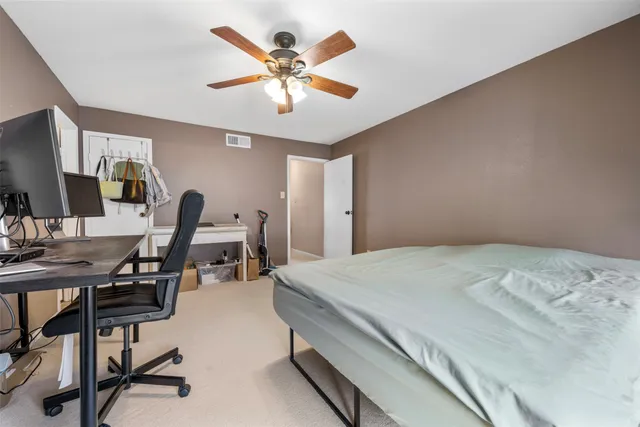 a bedroom with a bed a desk and chair