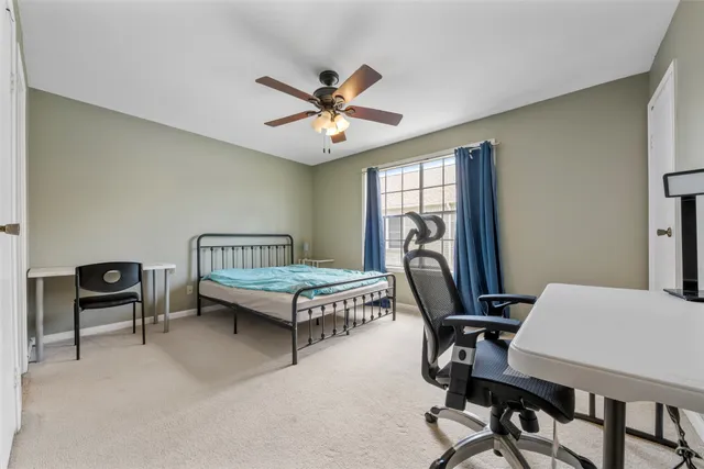 a bedroom with a bed a desk and chair