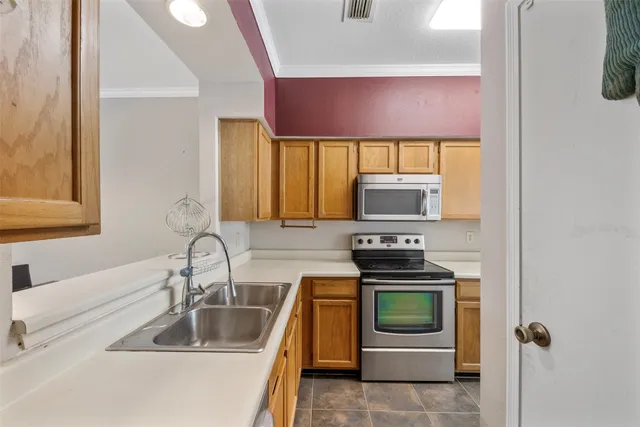 a kitchen with a stove and a sink