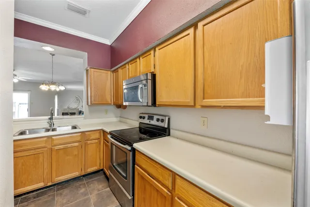 a kitchen with a sink a stove and cabinets