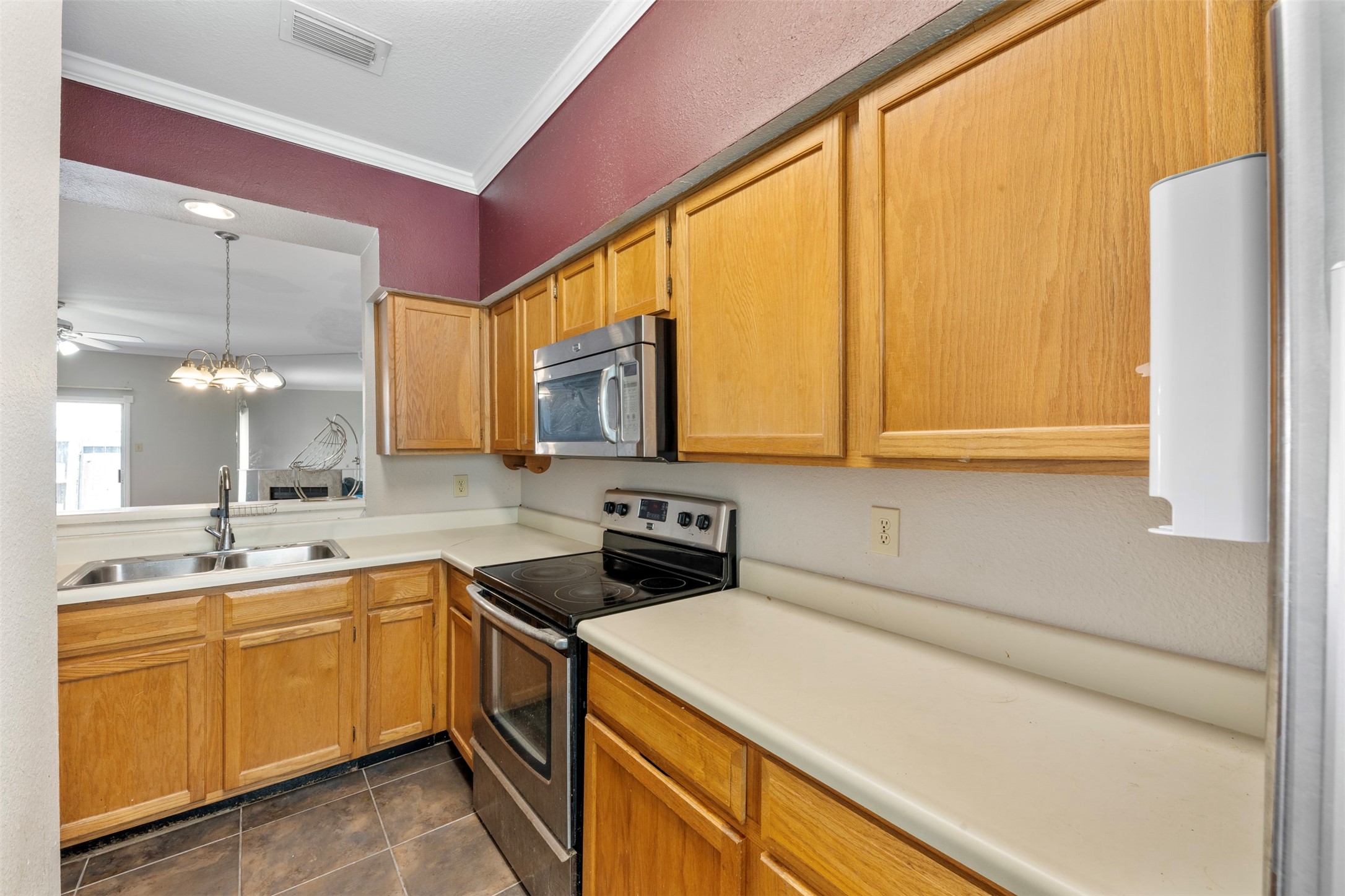 7617 Cambridge Street, Unit 7617 Houston, TX 77054 - Photo 9 of 20 a kitchen with a sink a stove and cabinets