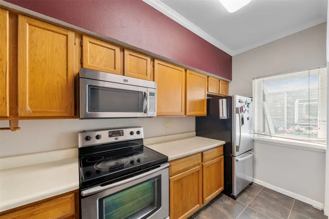a kitchen with a stove a sink and a microwave