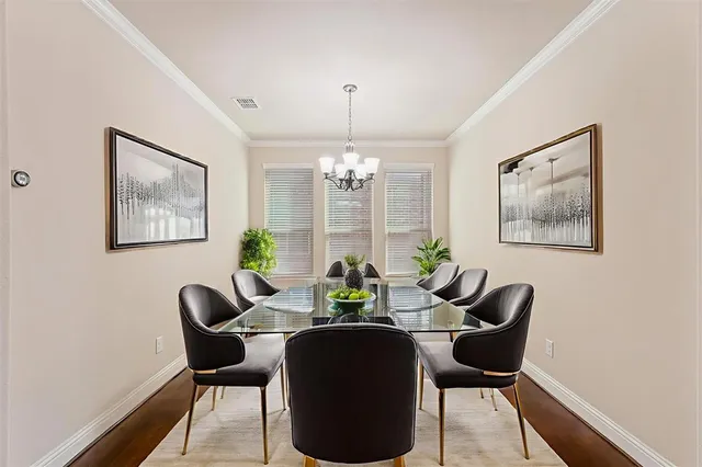 a dining room with furniture a chandelier and wooden floor