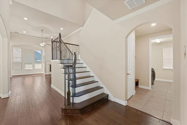a view of a hallway with wooden floor and entryway
