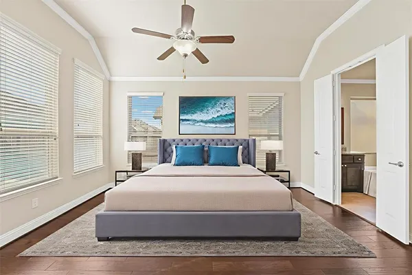 a spacious bedroom with a large bed and a chandelier