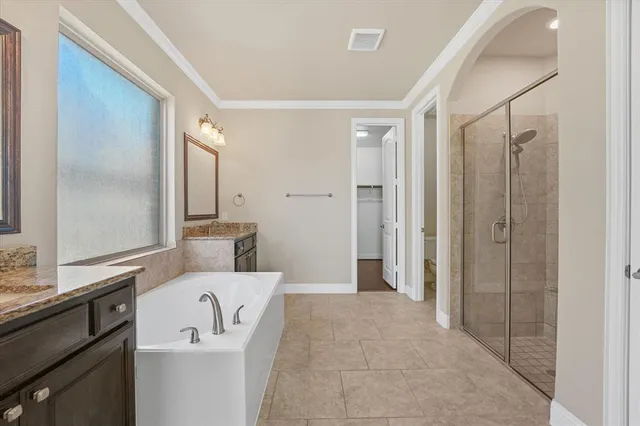 a en suite bathroom with a sink a mirror and a shower