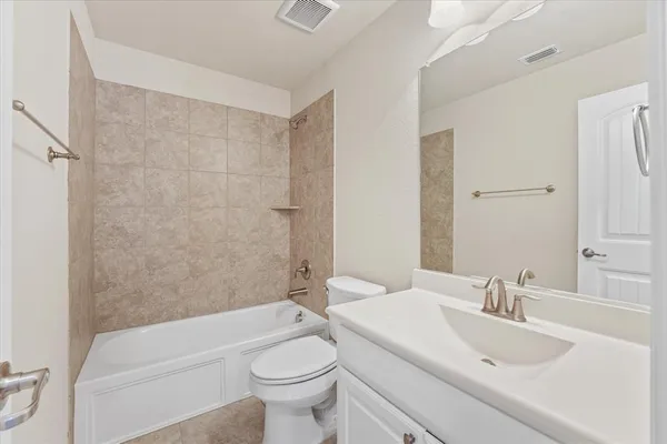 an empty room with chandelier fan