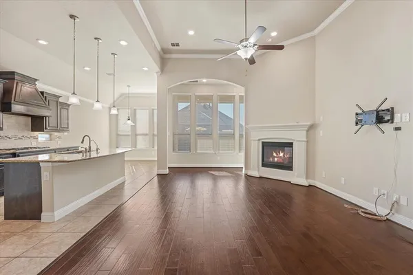 a large kitchen with cabinets a sink appliances and a fireplace