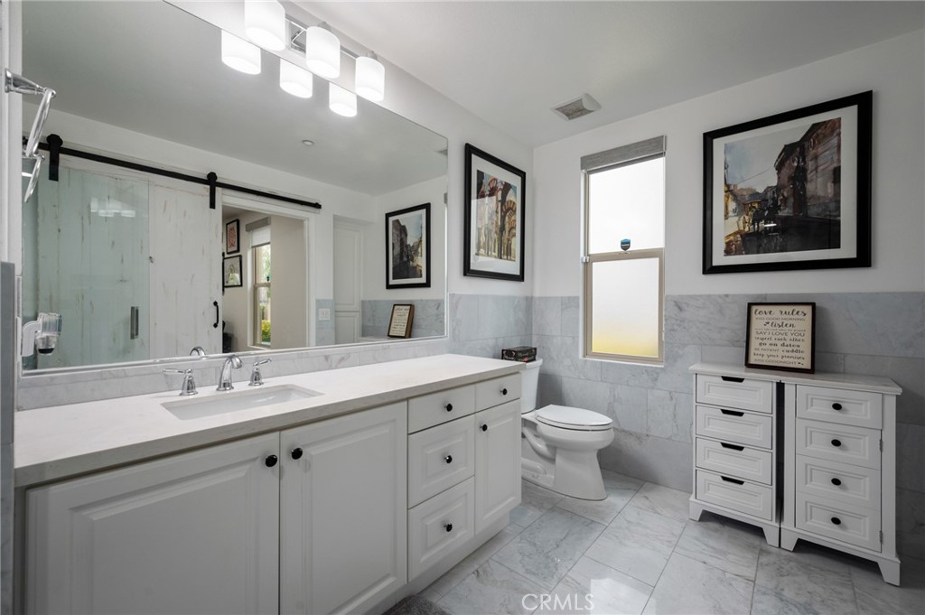5441 Ocean, Unit 101 Hawthorne, CA 90250 - Photo 25 of 37 a spacious bathroom with double sink a large mirror a toilet and a shower
