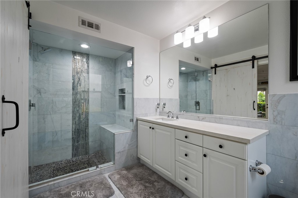 5441 Ocean, Unit 101 Hawthorne, CA 90250 - Photo 26 of 37 a bathroom with a double vanity sink mirror and shower