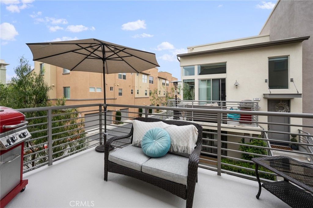 5441 Ocean, Unit 101 Hawthorne, CA 90250 - Photo 3 of 37 a roof deck with table and chairs under an umbrella