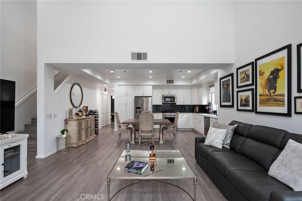 5441 Ocean, Unit 101 Hawthorne, CA 90250 - Photo 5 of 37 a living room with furniture kitchen view and a wooden floor