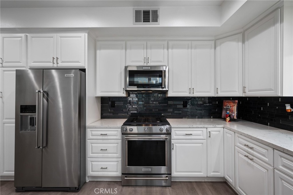 5441 Ocean, Unit 101 Hawthorne, CA 90250 - Photo 6 of 37 a kitchen with granite countertop white cabinets and stainless steel appliances