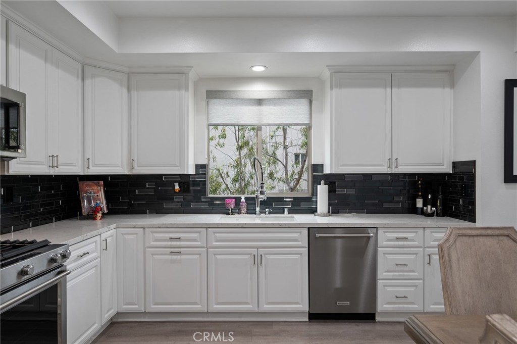 5441 Ocean, Unit 101 Hawthorne, CA 90250 - Photo 8 of 37 a kitchen with white cabinets and appliances