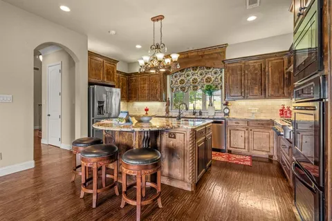 a kitchen with stainless steel appliances granite countertop a sink and stove