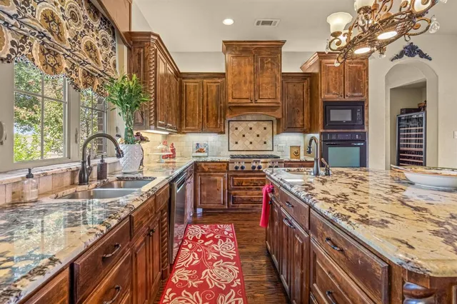 a kitchen with granite countertop a stove and cabinets