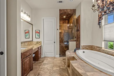 a bathroom with a tub sink and mirror
