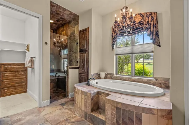 a bathroom with a granite countertop sink a mirror and a shower