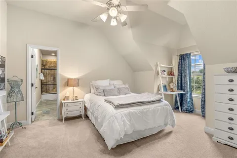 an empty room with closet and a ceiling fan