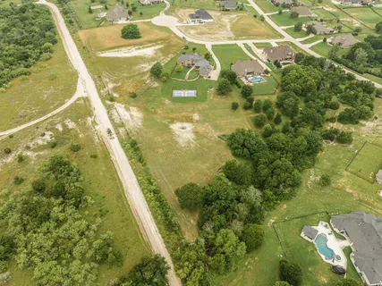 an aerial view of residential houses with outdoor space and swimming pool