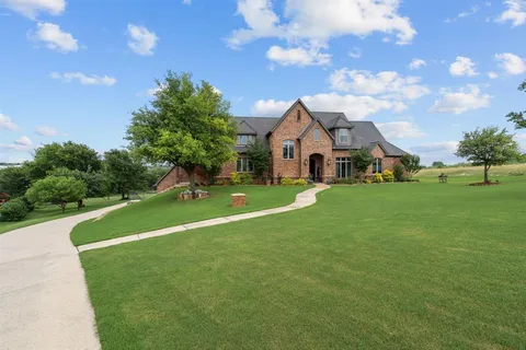 a front view of house with yard barbeque and outdoor seating