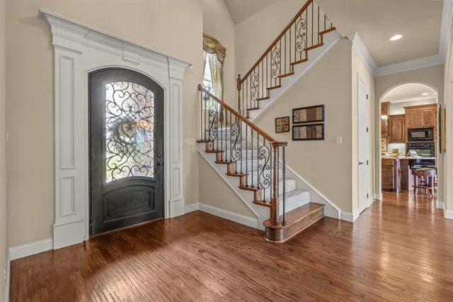 a view of entryway with wooden floor and stairs