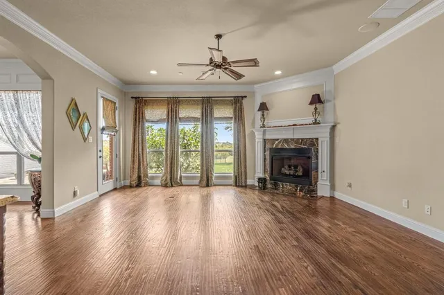 a view of an empty room with window and fire place