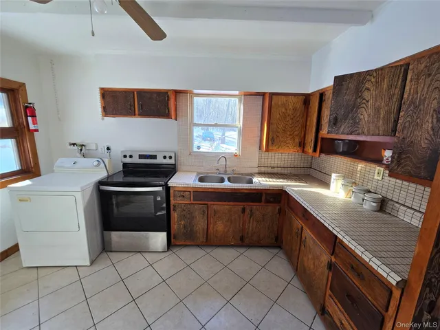a kitchen with a sink stove and cabinets