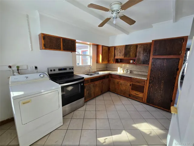 a kitchen with a stove sink and refrigerator