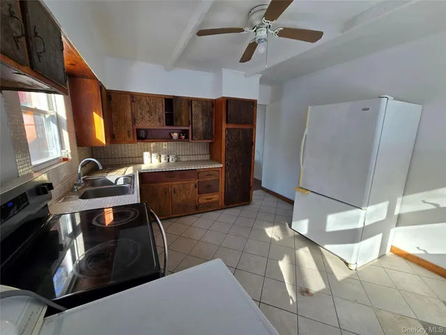 a kitchen with stainless steel appliances granite countertop a stove a refrigerator and a sink